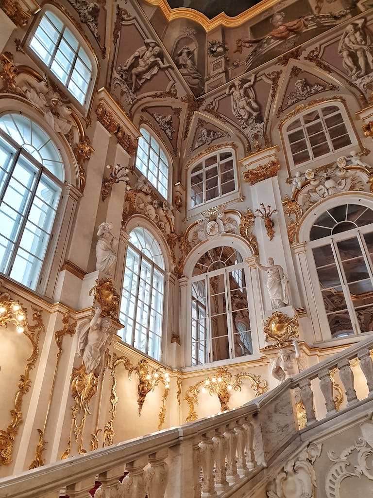 Luxurious Baroque interior with gilded details in Russia's Winter Palace, showcasing ornate design.
