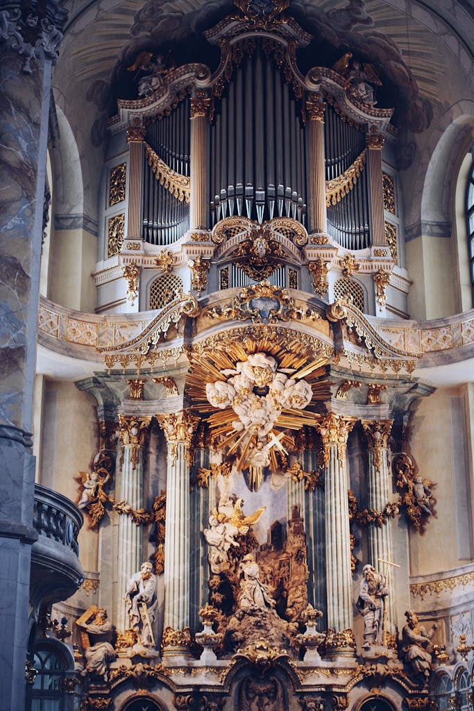 Luxurious baroque-style church interior showcasing intricate details and a stunning pipe organ.